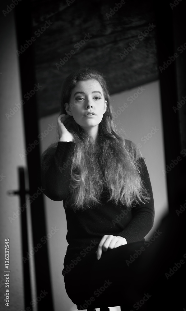 Beautiful Woman in Black Dress Looking at Herself in a Mirror Beautiful Woman in Black Dress Looking at Herself in a Mirror