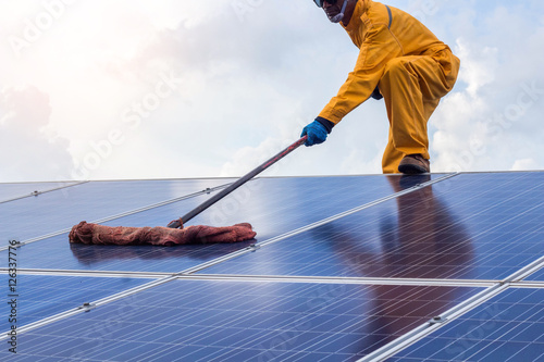 employee man clean of solar cell.
