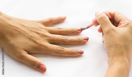 Nail polish in the woman hand.