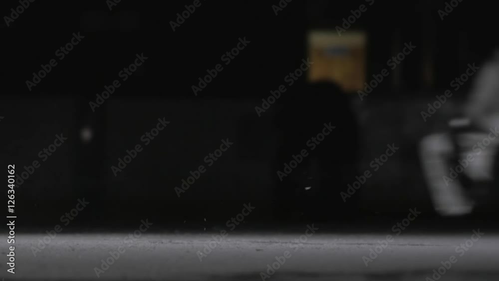 Hockey player make ice sparkles on high speed braking. Motion blur. Legs view only Hockey player make ice sparkles on high speed braking. Motion blur. Legs view only