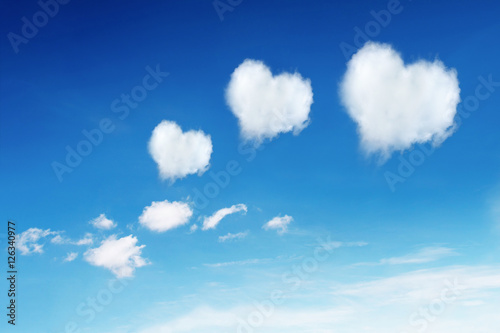Photography three heart shaped clouds on blue sky