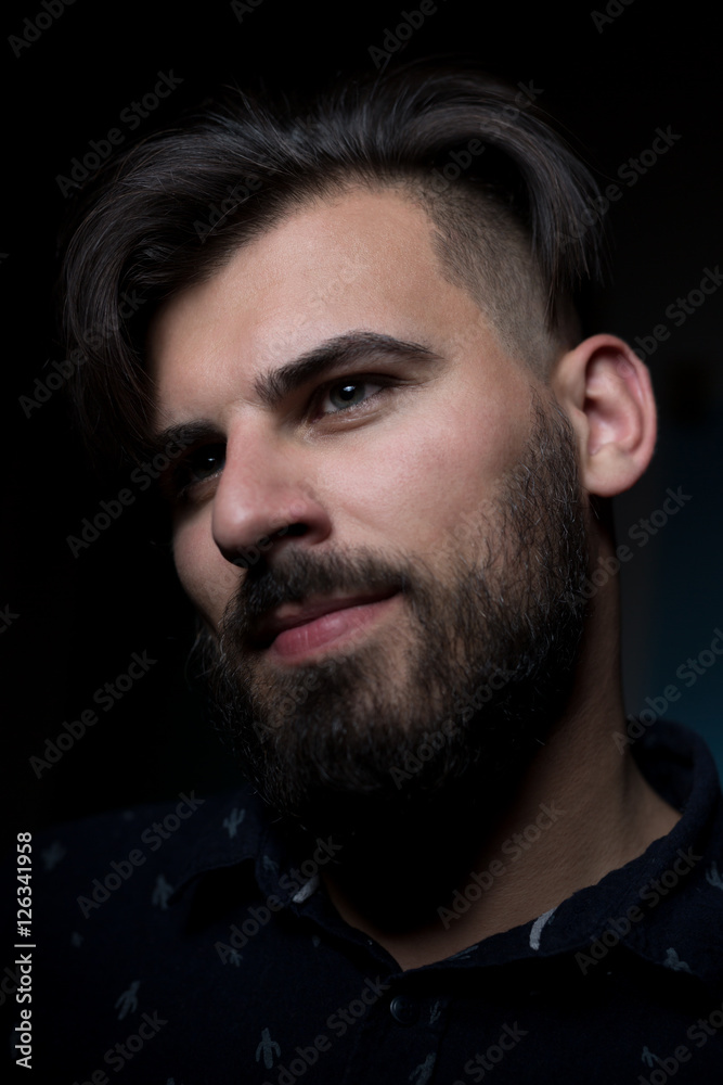 Fototapeta premium Attractive business man on dark studio background.