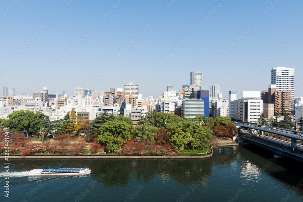 Skyscrapers of downtown Osaka, Japan. Osaka is a large port city and commercial center on the Japanese island of Honshu. It's known for its modern architecture, nightlife and hearty street food. Skyscrapers of downtown Osaka, Japan. Osaka is a large port city and commercial center on the Japanese island of Honshu. It's known for its modern architecture, nightlife and hearty street food.