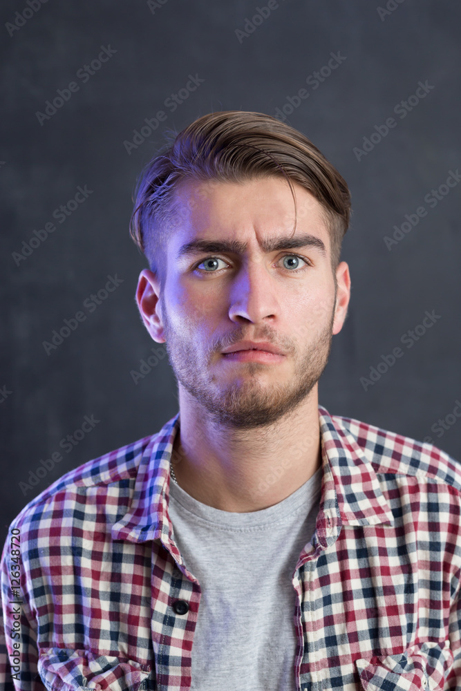 Portrait of a cheerful young man in checkered shirt Portrait of a cheerful young man in checkered shirt