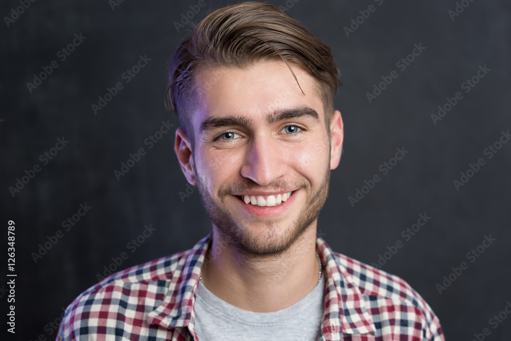 Portrait of a cheerful young man in checkered shirt Portrait of a cheerful young man in checkered shirt