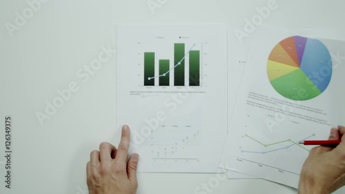 Man comparing graphic charts. photo