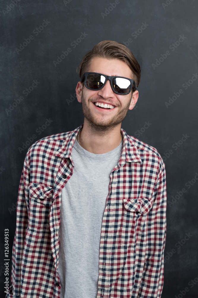 Portrait of a fashionable young man on dark background, chalkboa Portrait of a fashionable young man on dark background, chalkboa