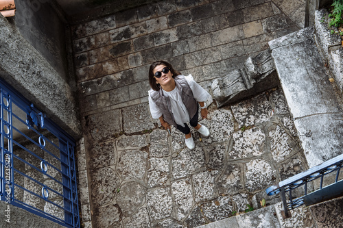 Young woman traveler walking through the city of Kotor, Monteneg photo