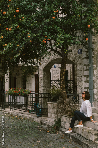 Young woman traveler walking through the city of Kotor, Monteneg photo