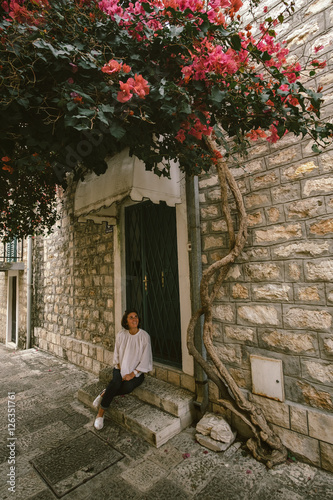 Young woman traveler walking through the city of Kotor, Monteneg photo