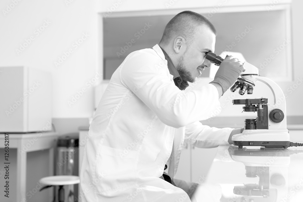 Young scientist investigating microbiological substance in micro Young scientist investigating microbiological substance in micro