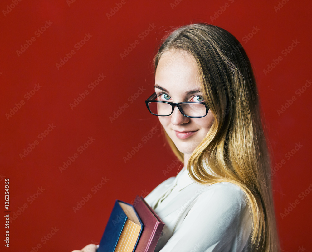 attractive happy smiling student blonde girl in white shirt with books on red background, student concept attractive happy smiling student blonde girl in white shirt with books on red background, student concept