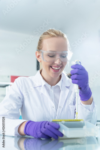 Fototapeta Naklejka Na Ścianę i Meble -  Young scientist in white uniform working in laboratory