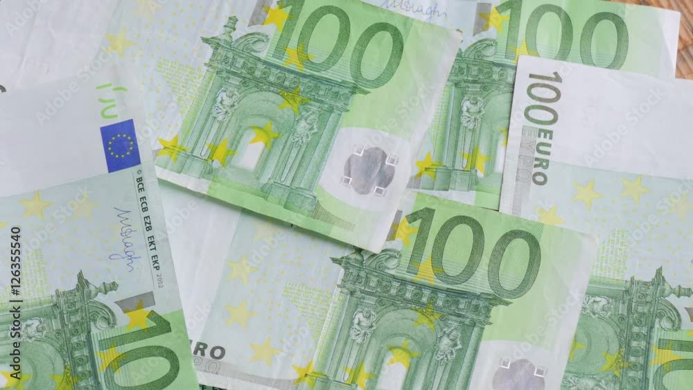 Euro banknotes in hands of young man / Young man puts euro banknotes on table Euro banknotes in hands of young man / Young man puts euro banknotes on table