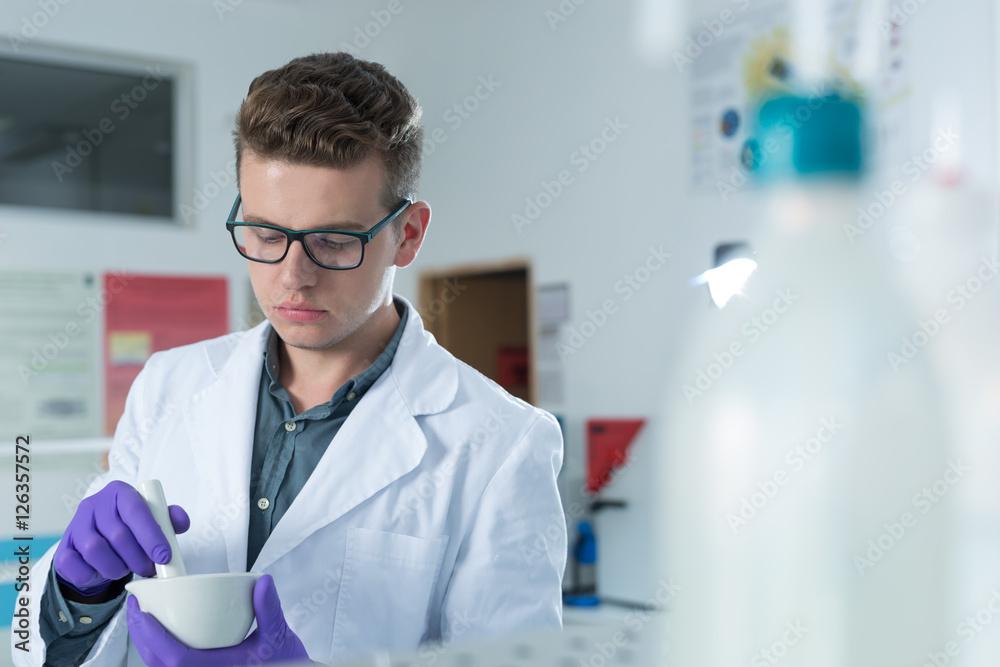 young doctor scientist in bright labaratory work research and an