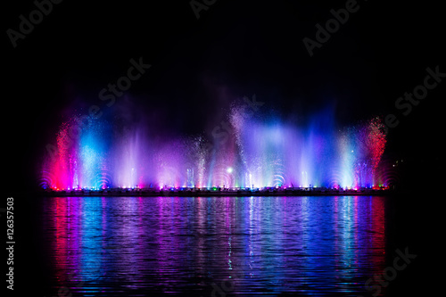 Fototapeta Naklejka Na Ścianę i Meble -  Beautiful fountain dancing show with reflection on water at night.