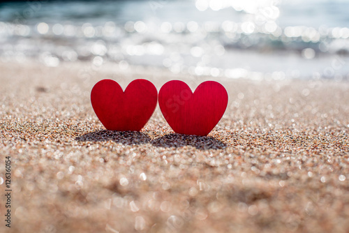 romantic symbol of two hearts on the beach photo