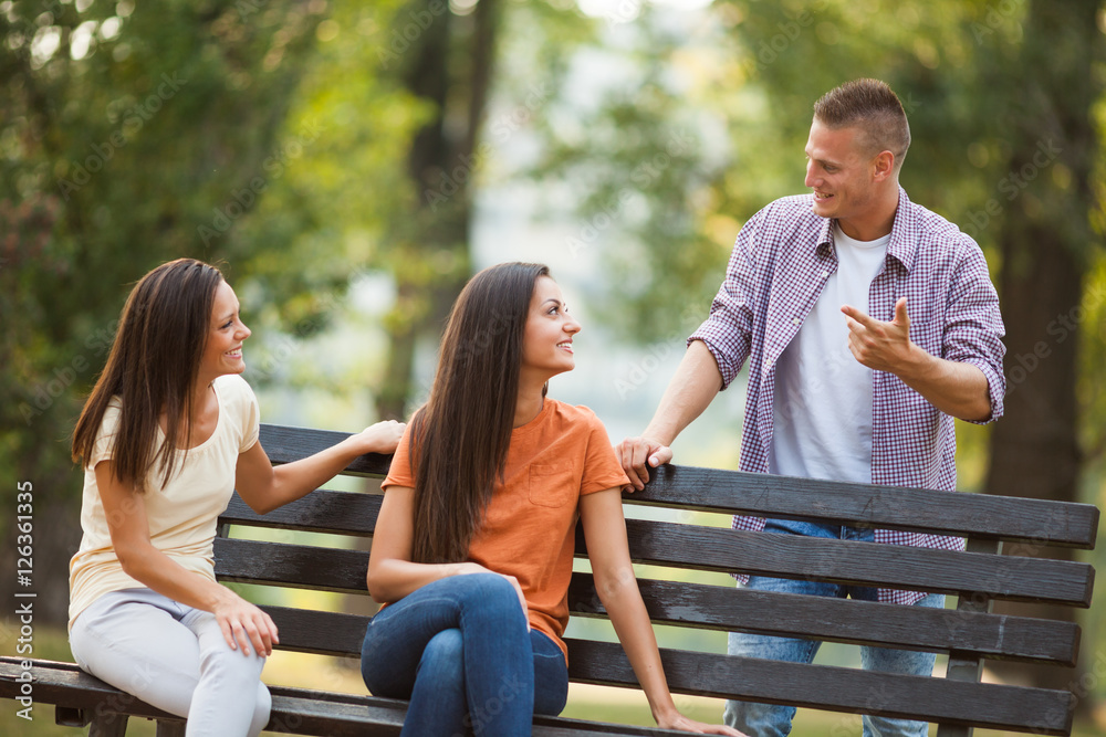 Three friends are having time together in park. Three friends are having time together in park.