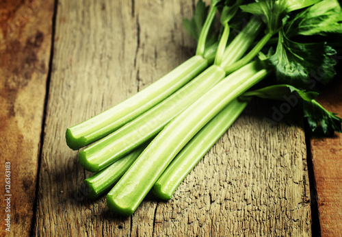 Stems of fresh celery with leaves on the table  vintage wooden b