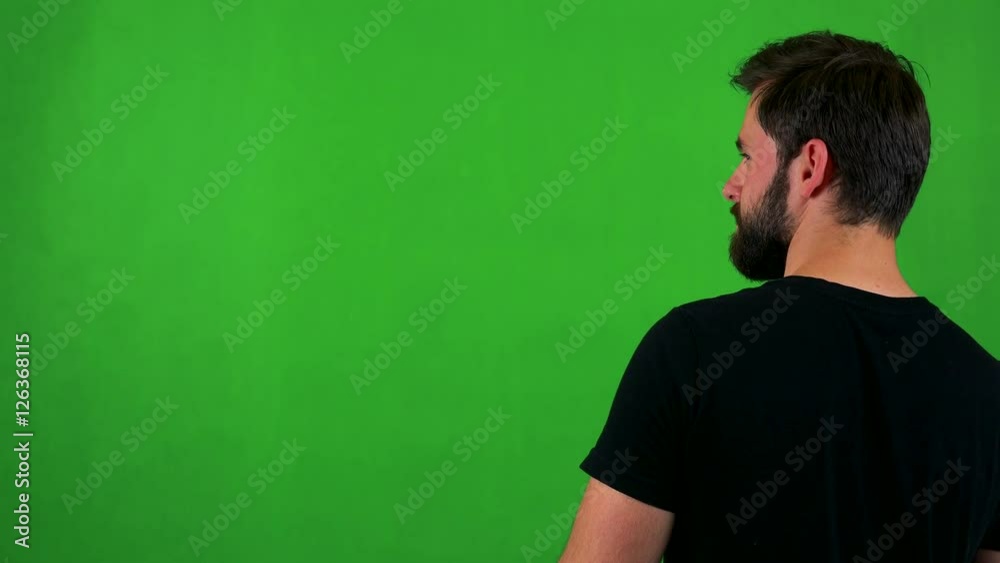 young handsome bearded man looks around - shot on back - green screen young handsome bearded man looks around - shot on back - green screen