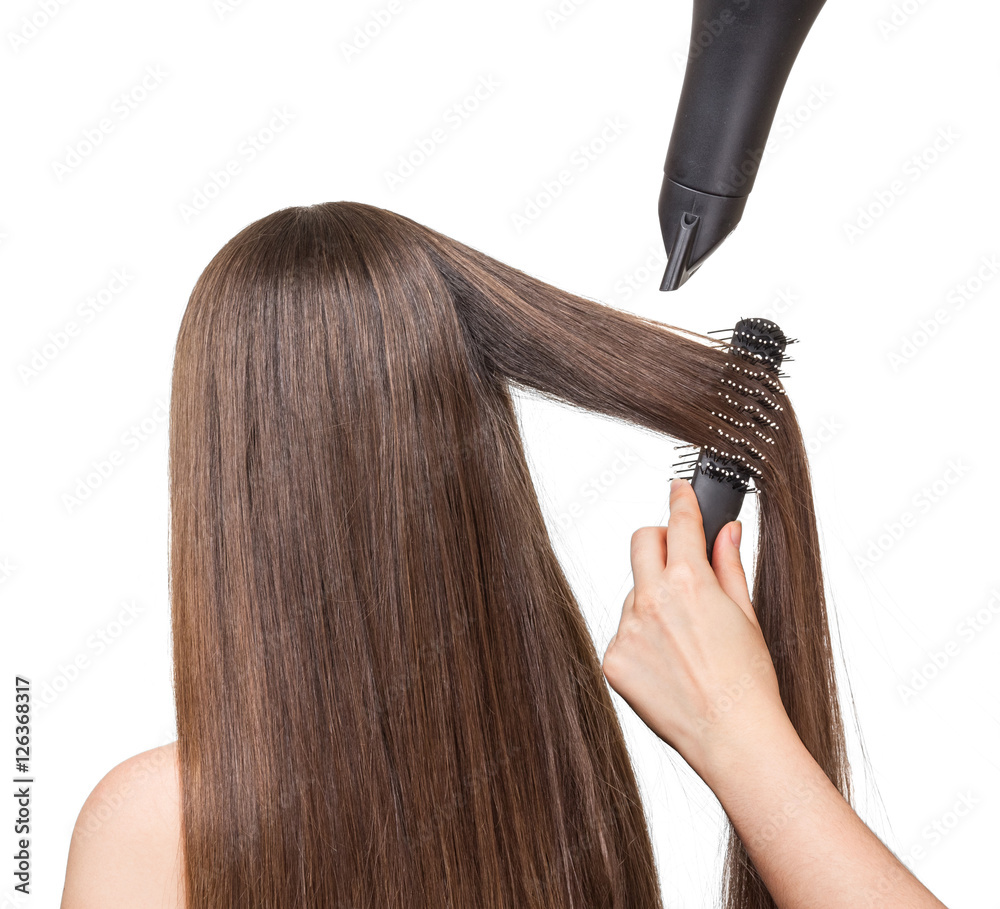 Fototapeta premium Girl with long hair, comb, hairdryer in hands hairdresser isolated.