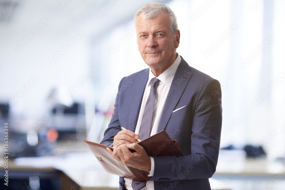 Senior professional man. Shot of a senior account manager standing in the office. Senior professional man. Shot of a senior account manager standing in the office.