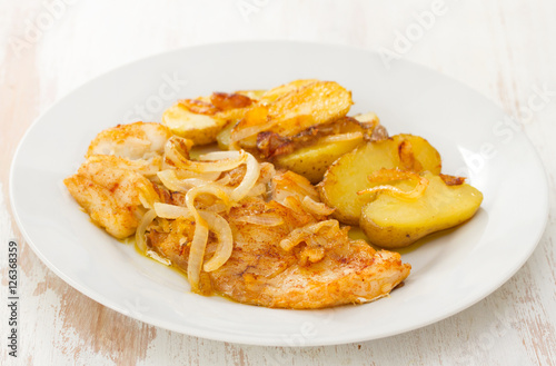 fried cod fish with potato on white plate