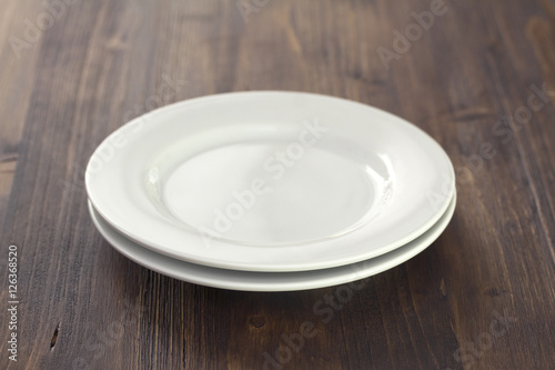 white plate on brown wooden background