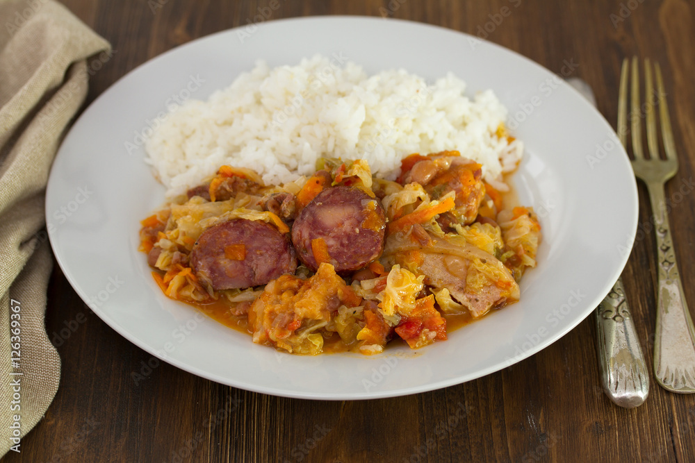 meat with cabbage, beans and rice on white dish meat with cabbage, beans and rice on white dish