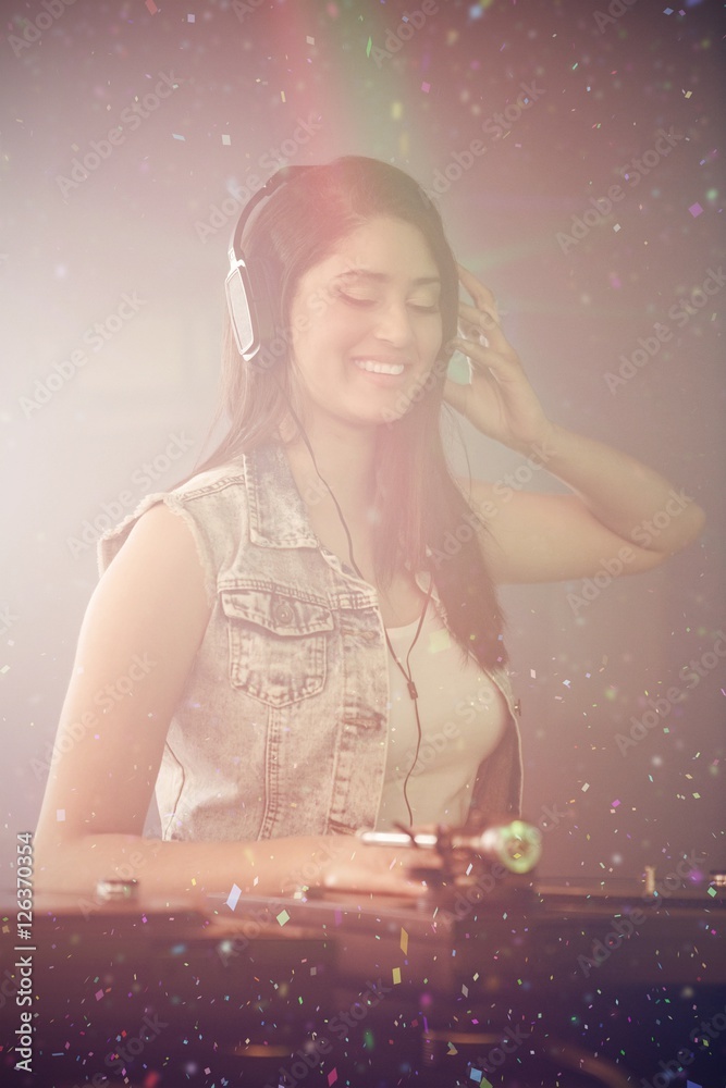 Composite image of pretty female dj playing music Composite image of pretty female dj playing music