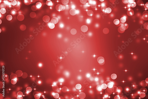 red festive abstract background with defocused lights and copy space for christmas card or happy new year greetings