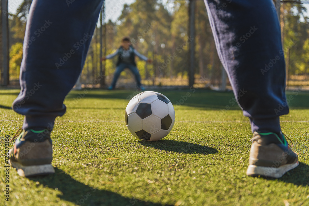 Father playing football with son