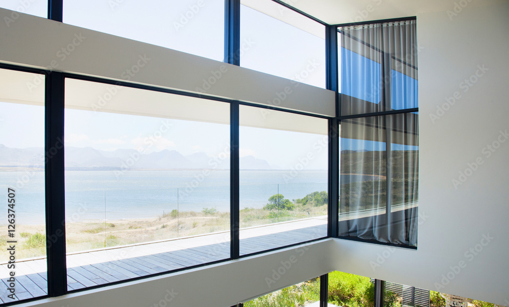 Fototapeta premium Glass wall in the office building. Modern sunny empty loft room