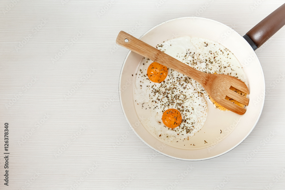 Fried eggs in the frying pan,breakfast ingredients.Cooking morning food.White Background.Top View.Food Texture Fried eggs in the frying pan,breakfast ingredients.Cooking morning food.White Background.Top View.Food Texture