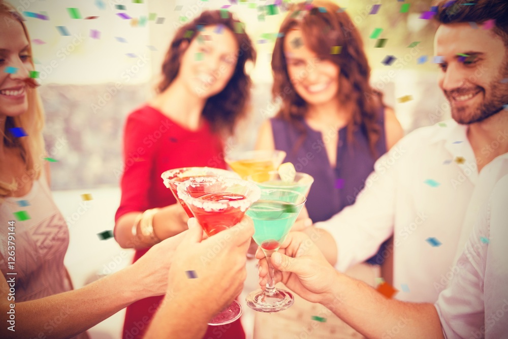 Composite image of cropped image of hand toasting cocktail Composite image of cropped image of hand toasting cocktail
