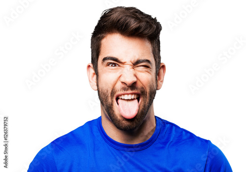 young man showing tongue