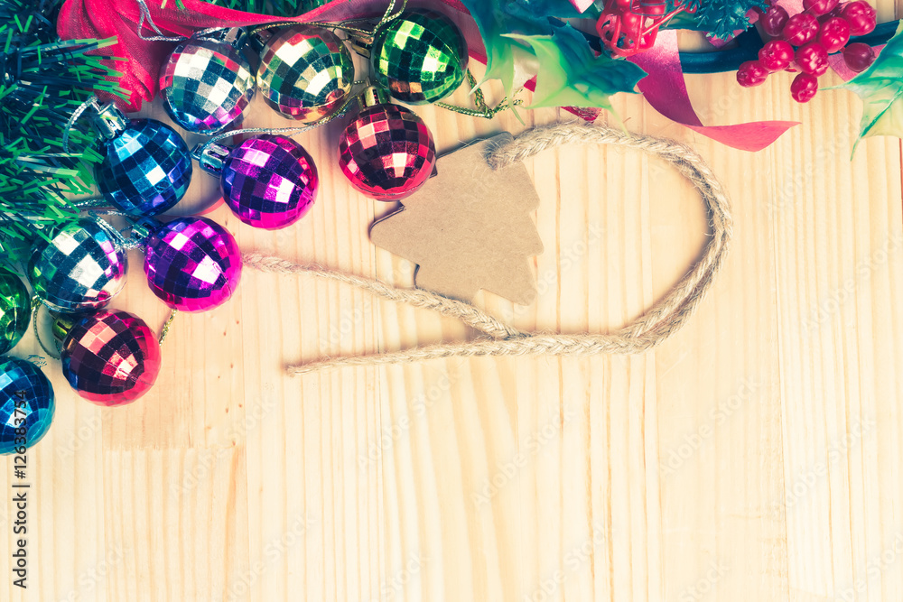 Christmas tree ornaments on natural wooden table.