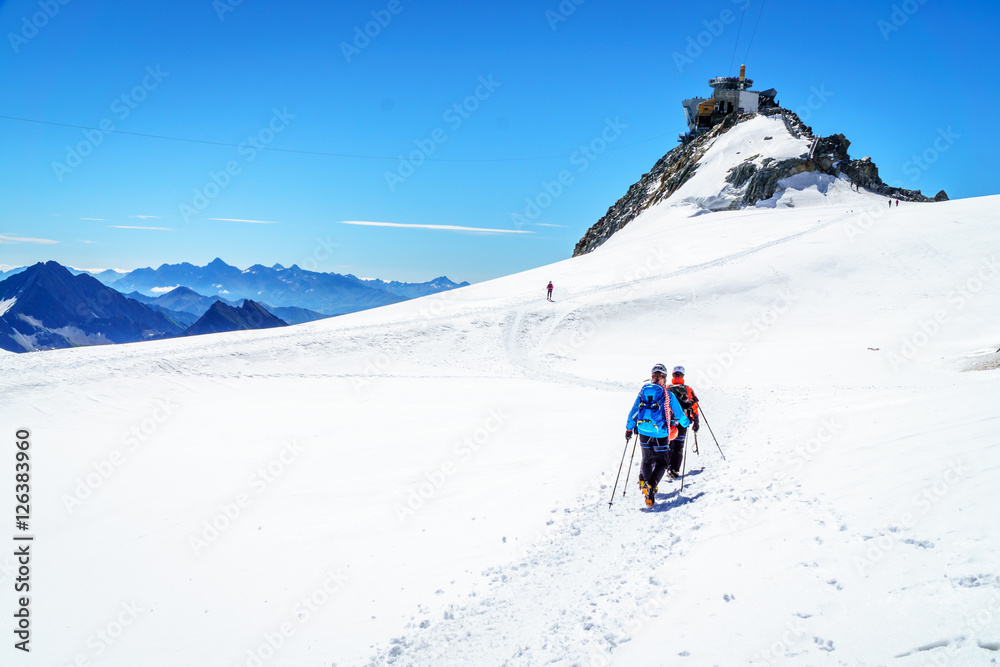 Mountaineers walking on the summit of Mont Blanc