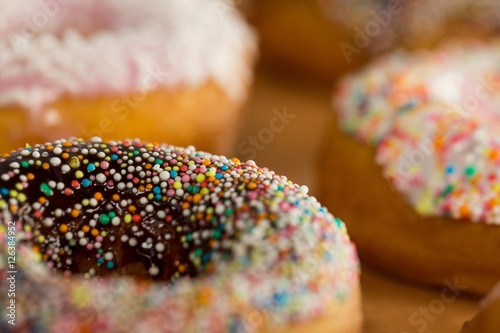 Fototapet Close-up of tasty doughnuts with sprinkles