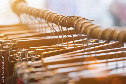 Many wooden hangers on a stick