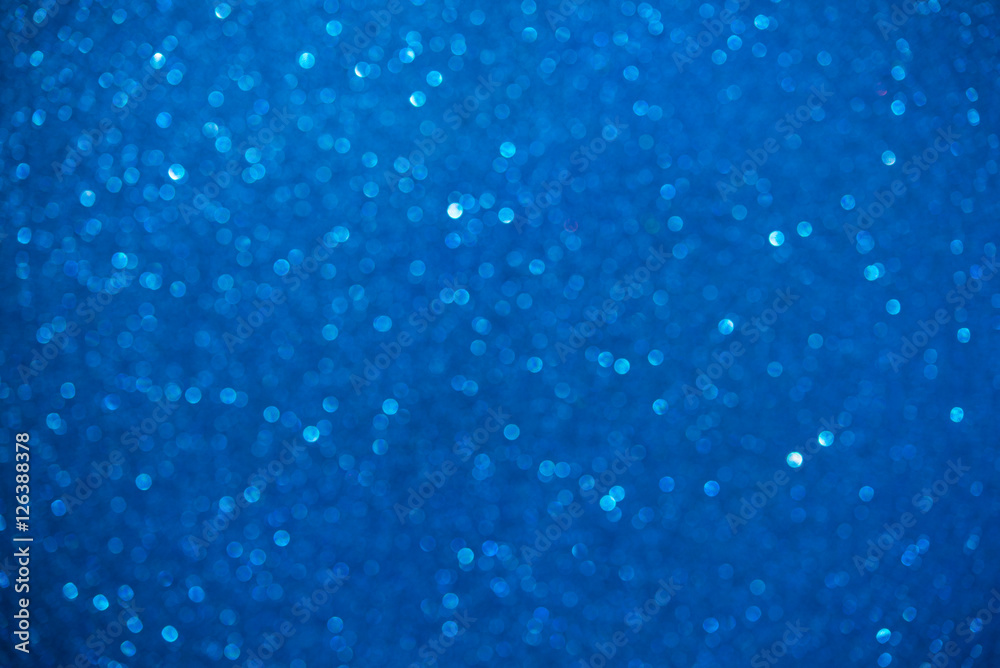 Unfocused abstract blue glitter bokeh holiday background. Winter xmas holidays. Christmas.