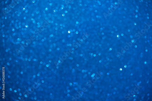 Unfocused abstract blue glitter bokeh holiday background. Winter xmas holidays. Christmas.