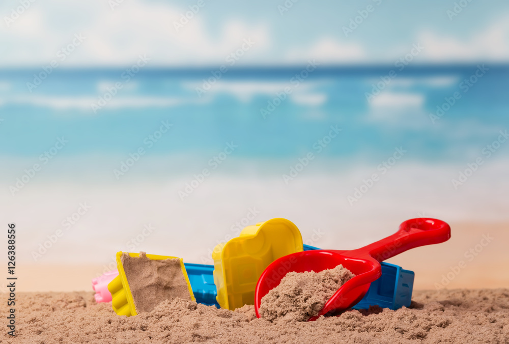 Bright children's toys in the sand against sea. Bright children's toys in the sand against sea.