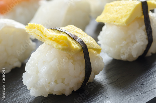 Sushi nigiri set on slate plate.