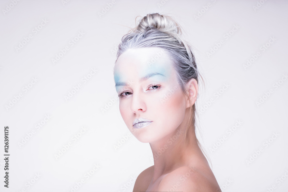 Model in creative image with silver blue artistic make-up Model in creative image with silver blue artistic make-up