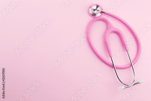 Pink stethoscope on pink background © Africa Studio