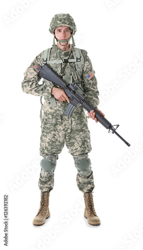 Soldier in camouflage holding rifle, isolated on white