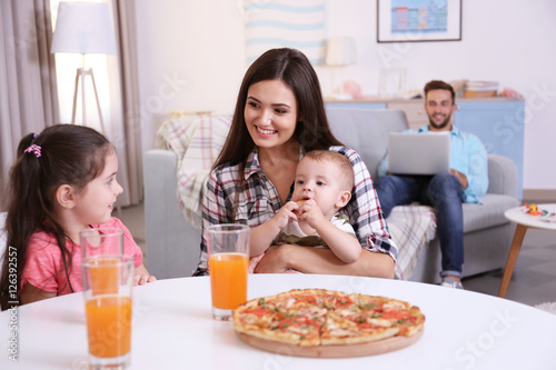 Happy family eating food on...