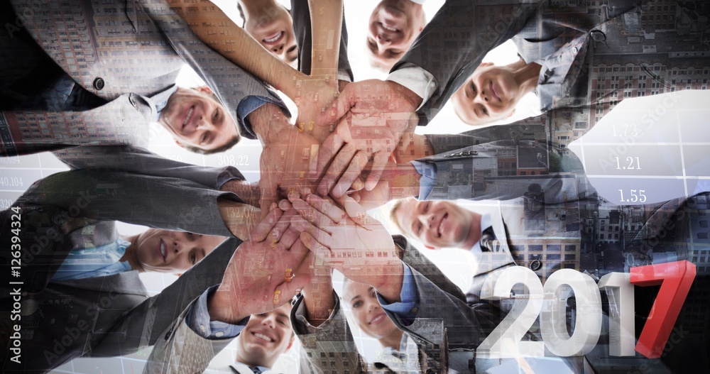 Obraz premium Composite image of smiling business team standing in circle hand