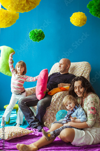 happy and beautiful family having fun together in studio